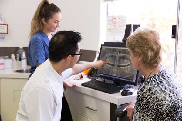 Dentist and patient viewing dental xray